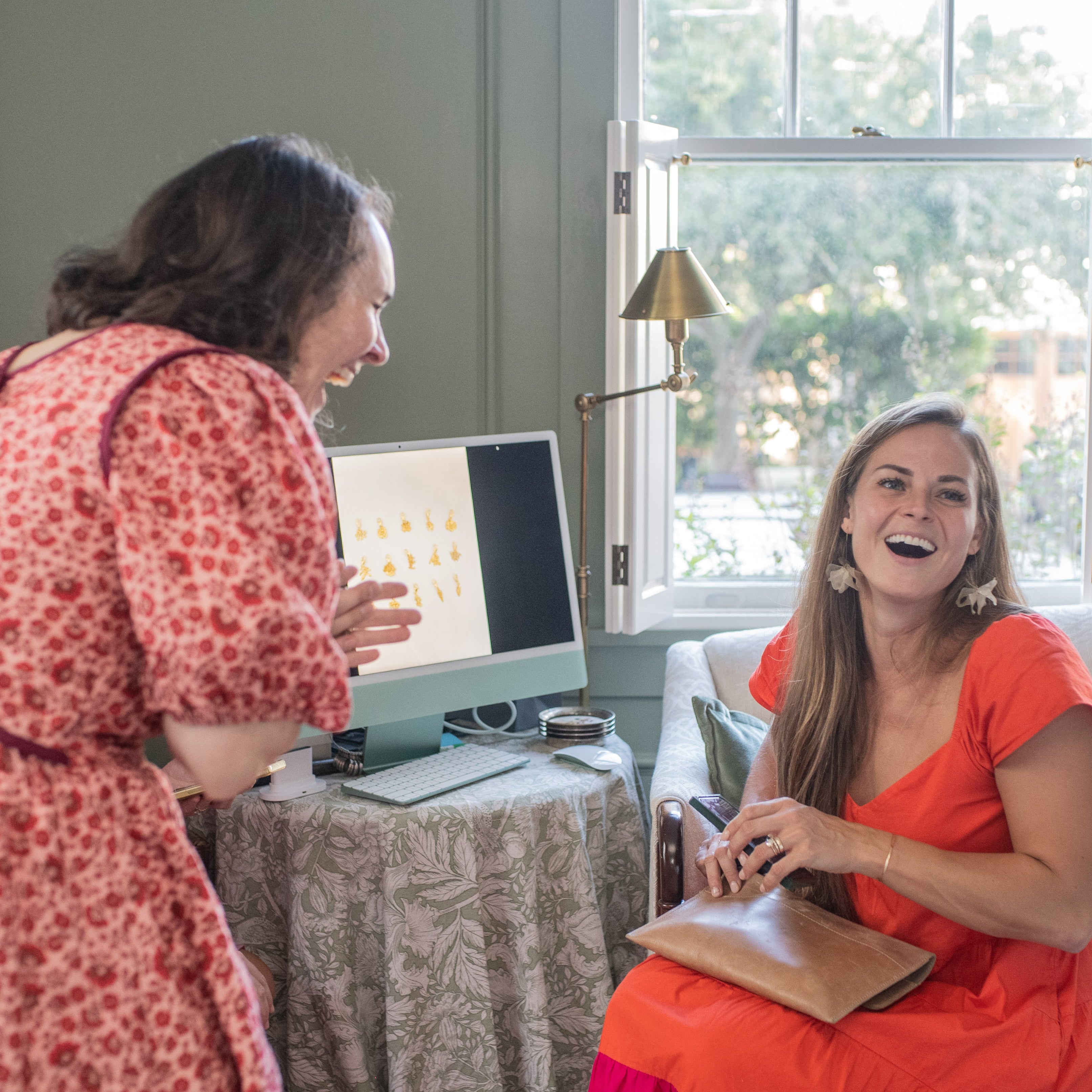 Client receiving a finished custom jewelry piece from Mary Frances Maker