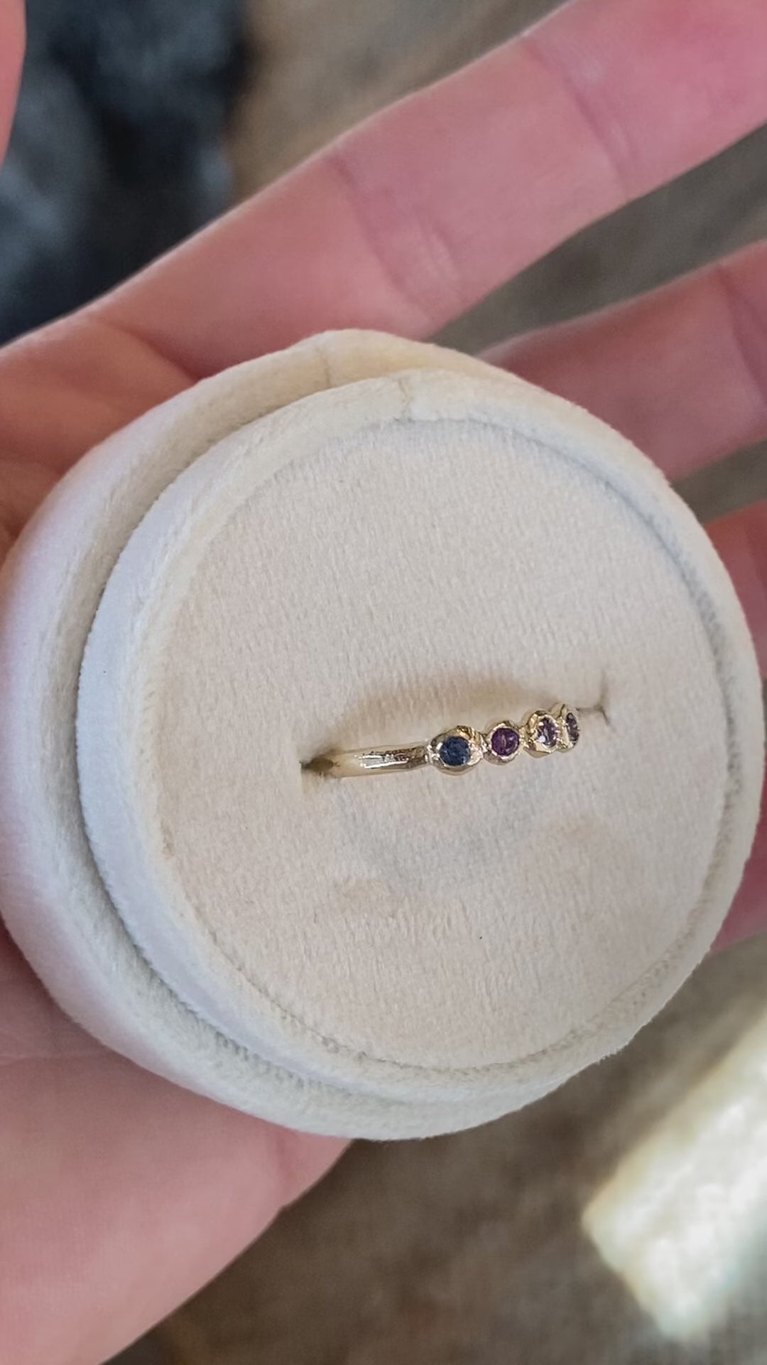video of four birthstone ring with blues and purple colored stones